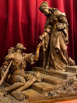 Wood Carved Statue Of Saint Elizabeth Giving A Coin With Her Right Hand To The Left Hand Of Beggar As Charity Gesture style Gothic - style en Hand - Carved Wood , Ortisei Sud Tirol Italy  20th century